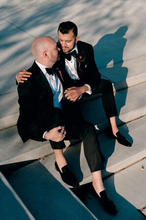 Grooms in Black-Tie Tuxes Sitting on Stairs for Wedding Portraits