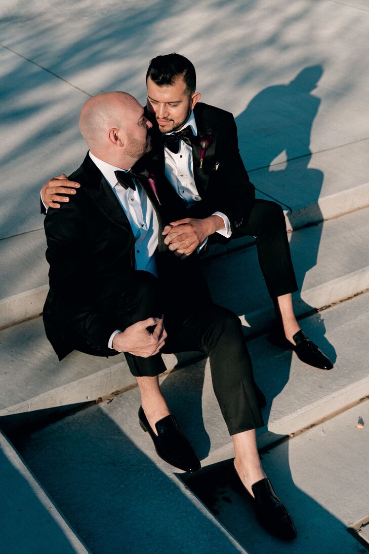 Grooms in Black-Tie Tuxes Sitting on Stairs for Wedding Portraits