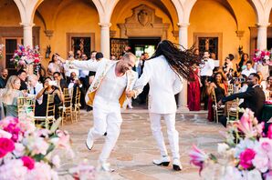 Stylish Grooms Dance Energetically Together at Romantic Courtyard Reception