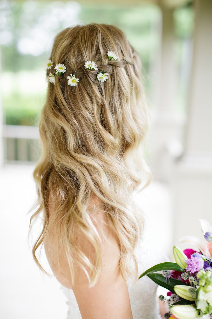 The bride wore her hair in long, loose waves along with a delicate crown of white daisies.