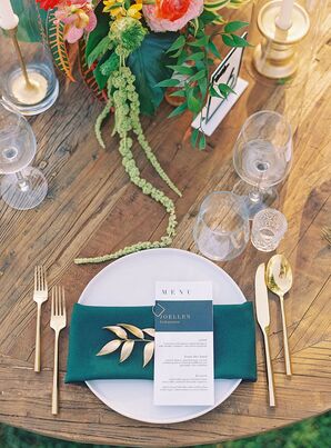 Elegant Place Setting With White Charger, Emerald Green Details and a Modern Menu