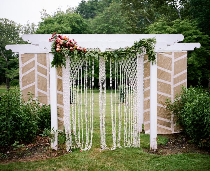 We can’t take our eyes off their ceremony backdrop. Handcrafted by Maggie of Maggpie Vintage Rental and coordinated with florals from Belovely Floral and Event Design, their decoration fit the natural setting with a few modern twists. Bohemian macrame, or knotted white rope, cascaded down the center for a beautiful design. Chevron-inspired neutral and white panels surrounded each piece below a white vintage-style arbor. Their florists added a chic garland of fern leaves, eucalyptus, greenery, pink proteas, and magenta and pink garden roses to the top. This accent even matched the rest of their floral arrangements.