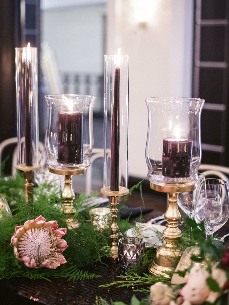 black candles with gold candle holders