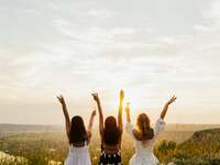 Group of friends holding wine glasses in the air at bachelorette party