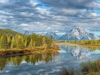 The mountain rise over the river at Jackson Hole, Wyoming.