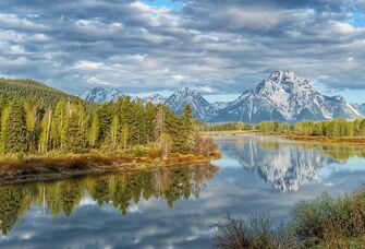 The mountain rise over the river at Jackson Hole, Wyoming.
