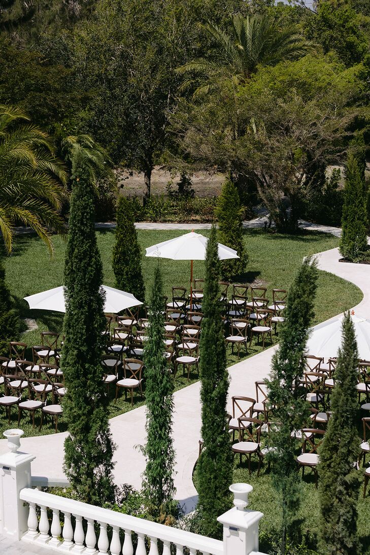 Alfresco Ceremony on Estate Lawn, White Umbrellas and Wooden Chairs