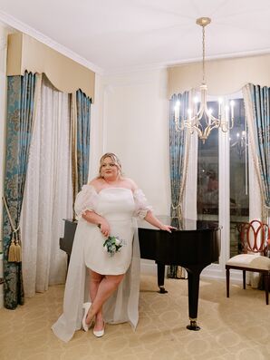 Bride in Retro Minidress, White Heels, Puff Sleeves and Cape in Hotel