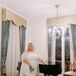 Bride in Retro Minidress, White Heels, Puff Sleeves and Cape in Hotel