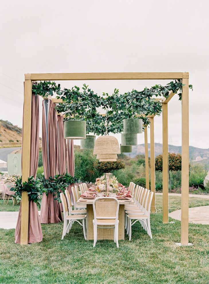 Wood Cabana Over Head Table, Blush Draping, Greenery and Chandeliers