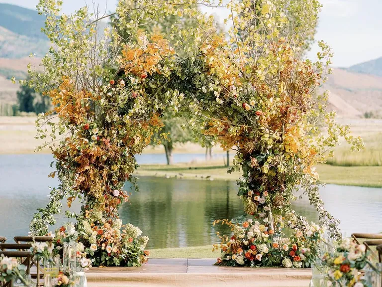 Fall Wedding Ceremony Arch With Orange Leaves