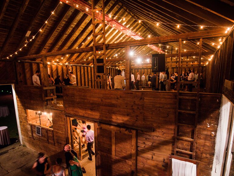 Guests dance during the reception at a barn wedding