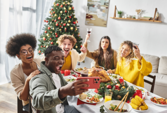 Friends taking selfie at Christmas party