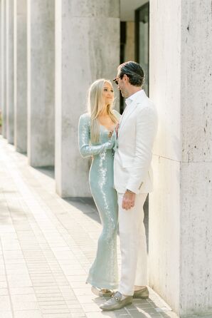 Bride in Pale Blue, Fitted, Sequin Gown Posting With Groom in All-White Suite for Engagement Photos