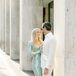 Bride in Pale Blue, Fitted, Sequin Gown Posting With Groom in All-White Suite for Engagement Photos