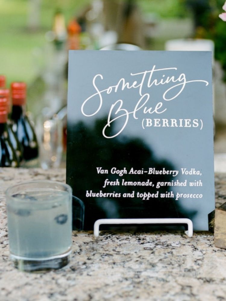blue signature cocktail and acrylic bar menu