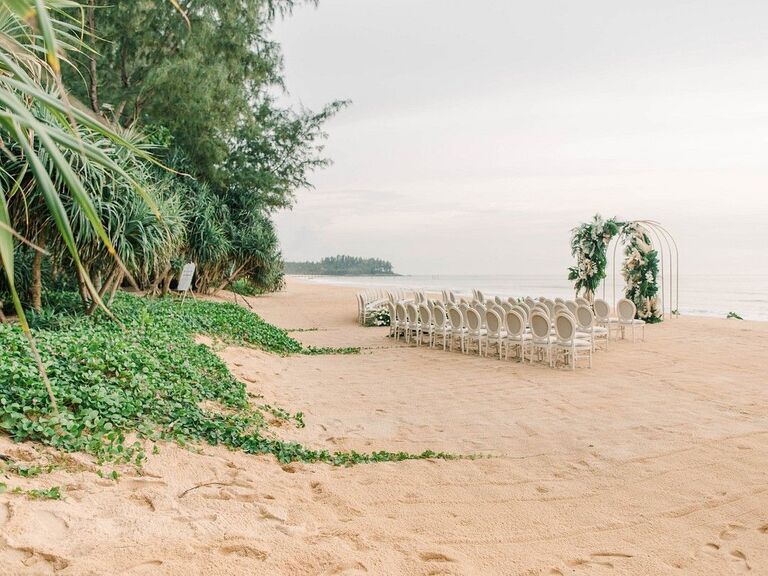 Chairs and altar arch for ceremony on the beach