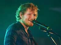Ed Sheeran singing into microphone