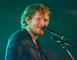 Ed Sheeran singing into microphone