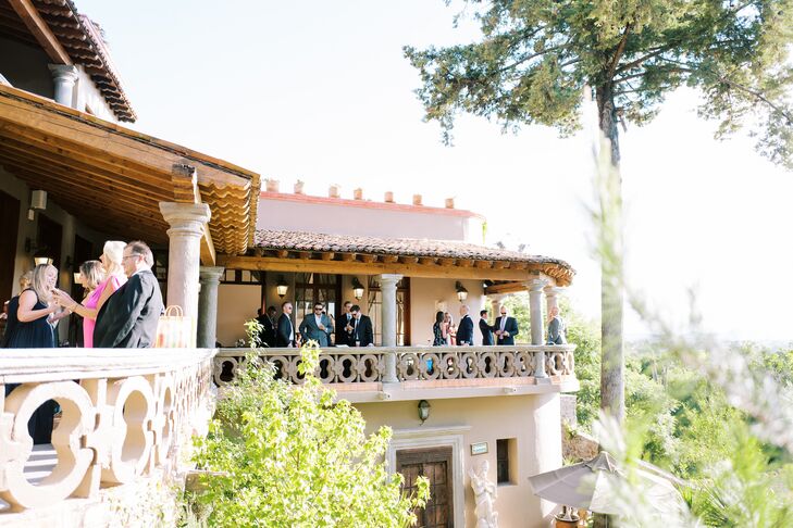 Guests Mingling on Balcony Overlooking Historic Venue in San Miguel de Allende, Mexico
