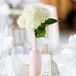 The table numbers were painted on circular tree slices and propped against small white lanterns.