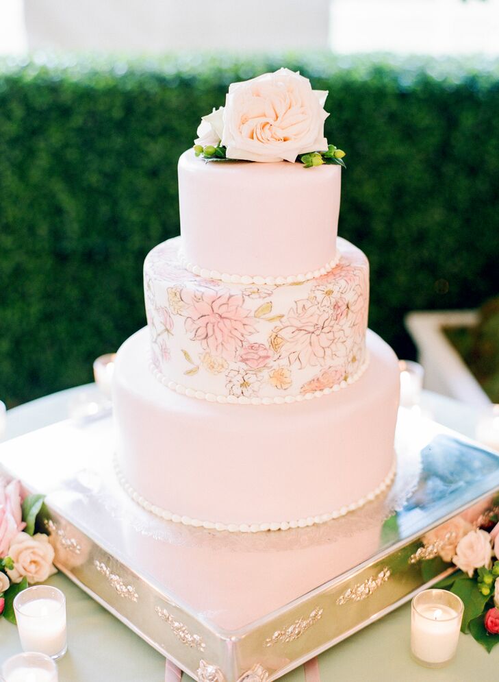 Two tiers of red velvet and another of coconut with strawberries were covered in light pink fondant and the same custom Inslee botanical watercolor design that was used on Kathryn and Ryan's invitation suite.
