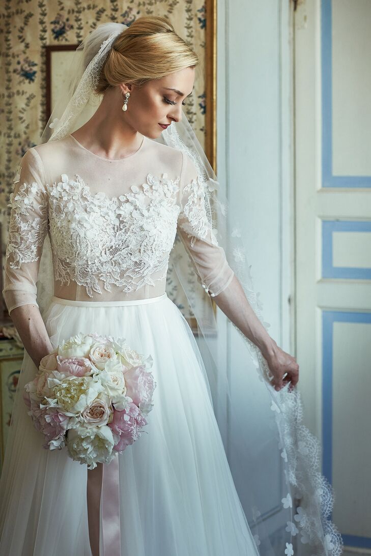 Nina wore a Papilio gown from the Swan Princess collection with woven lace on the semitransparent bodice and sleeves and a romantic tulle skirt.  "l felt like a ballerina in it," Nina says. "And that is a part of me, because I have danced ballet since I was 4 years old, and I have always loved the ballet. The dress is from a collection that was inspired by the ballet. The gown was dainty, elegant and feminine, and as soon as I put it on, it felt like my gown."