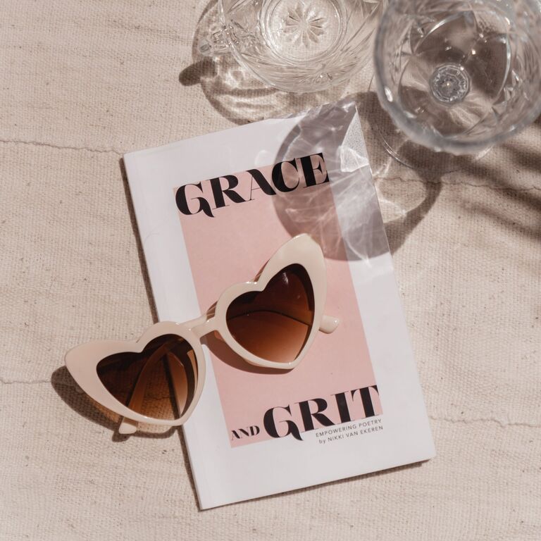 Nude heart-shaped sunglasses on a booklet from Birdy Grey