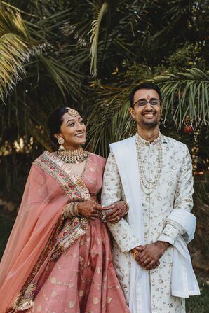 Bride in Rose Colored Lehenga, Jewelry, and Groom in White Ivory Sherwani, Indian Wedding