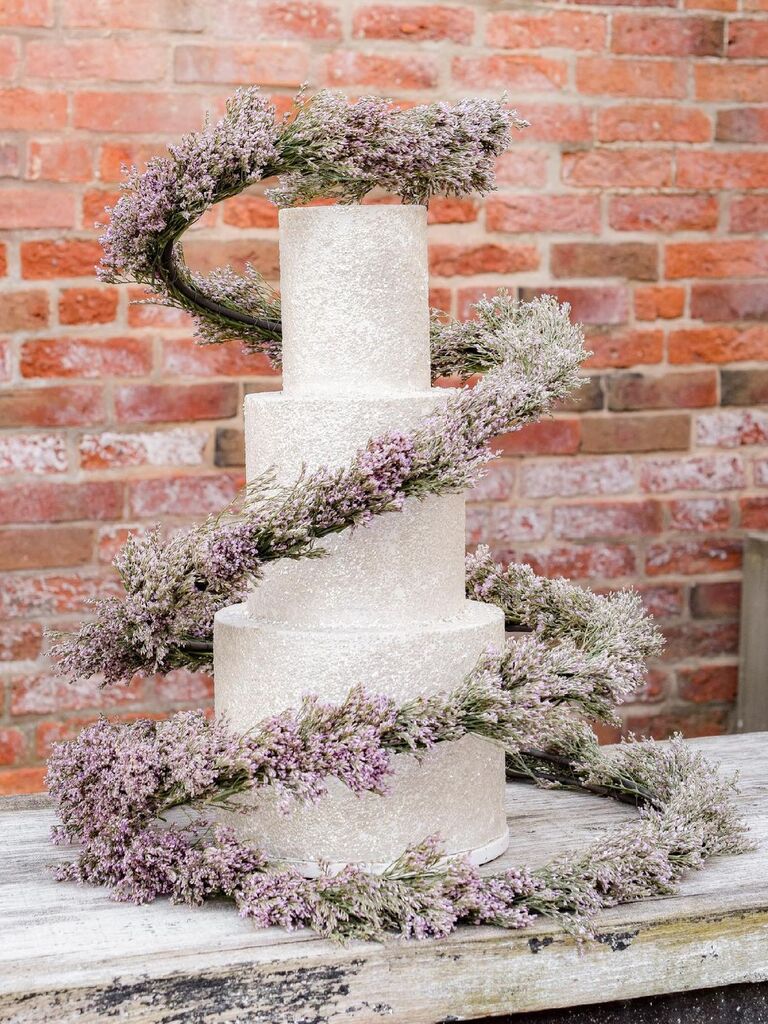 three tier wedding cake with 3D swirl of purple flowers