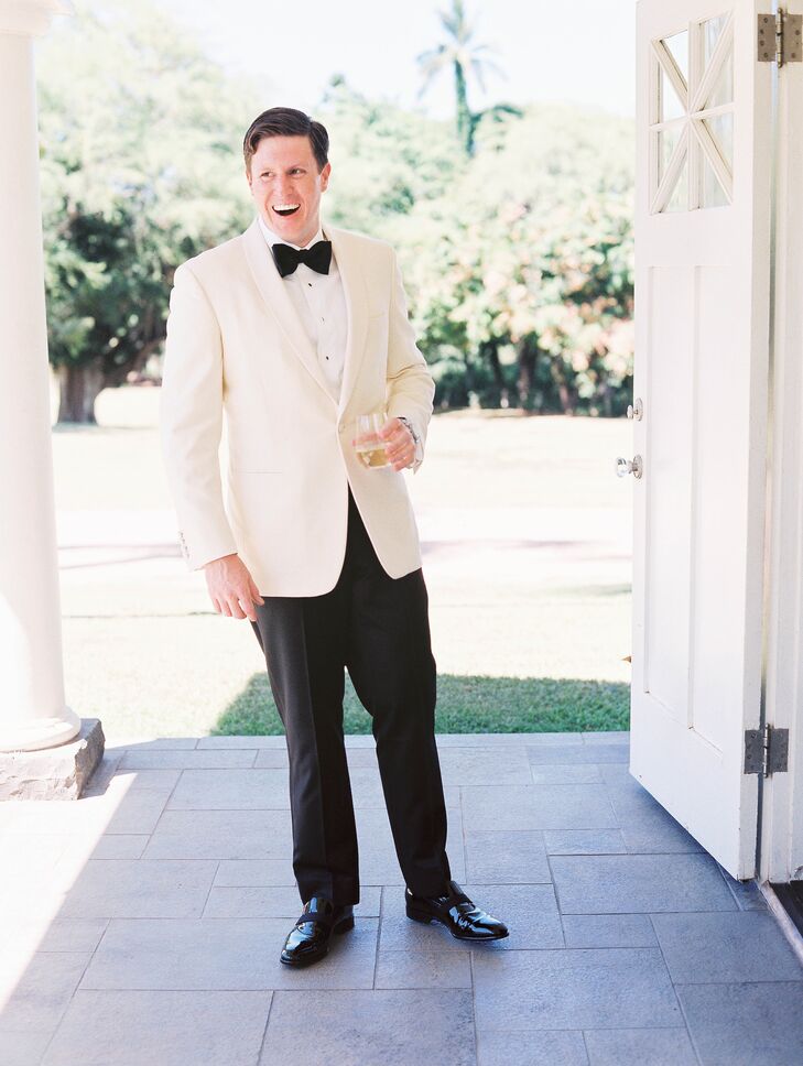 Bridesmaids wore breezy coral dresses, while the couple opted for a more formal look with white dinner jackets.