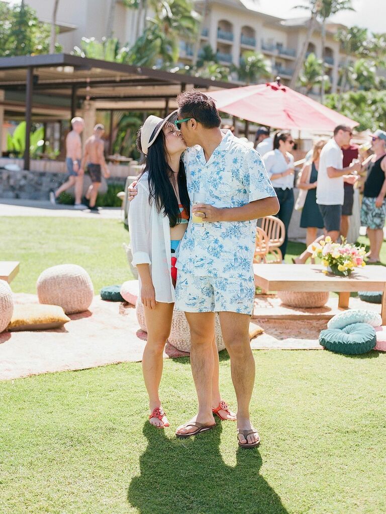 Couple kiss at an outdoor party. 