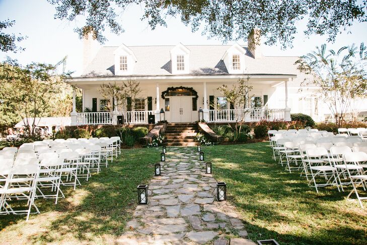 "We used white and blush pink in the ceremony area, as well as fresh greenery because I wanted a simple, organic feel to the setting," says Meg. "We married underneath an archway, facing the pond in front of my parents' home, with old church pews that had belonged in my great grandmother's church for seating."