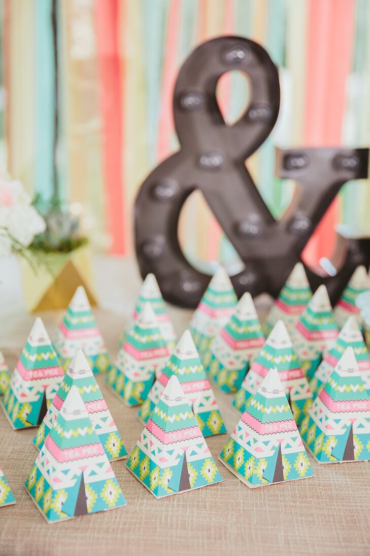 Guests took home green, pink and white geometric-patterned boxes shaped like teepees, which had organic tea bags. Mai and Brian called the crafty gifts "tea-pees."