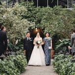 Bride walking down the aisle with parents