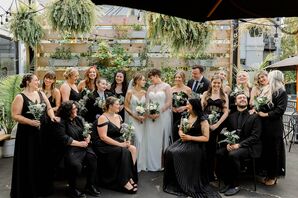 Brides and Mixed Gender Bridal Party in All Black, Greenery Wall With Hanging Plants