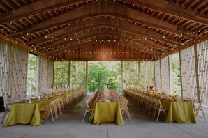 Wooden Gazebo Reception With String Lights, Yellow Tables With 1970s Vibe