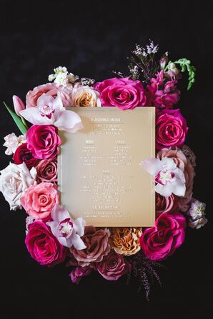 Gold, Art Deco Inspired Signature Cocktail Menu Surrounded By Pink and White Flowers