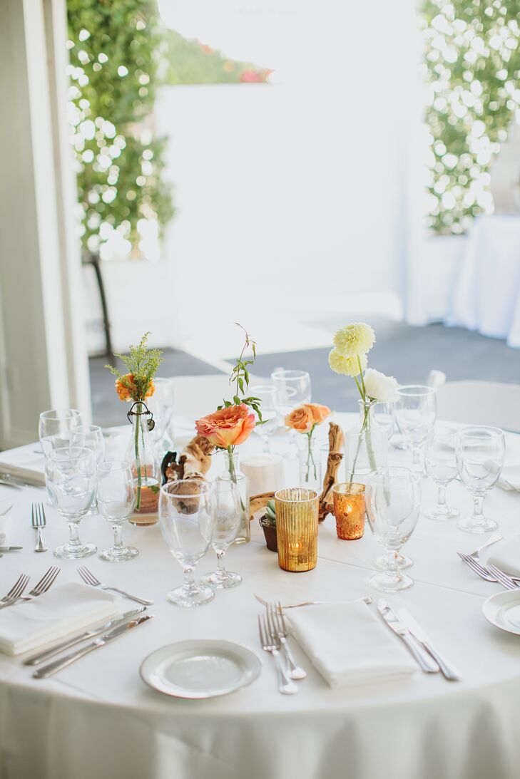 "Our reception decor had more of a desert-boho vibe," Gwynne says. "It was an eclectic combination of vintage bud vases and olive wood branches with copper and gold votives."