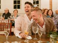 Couple laughs during their rehearsal dinner. 