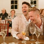 Couple laughs during their rehearsal dinner. 