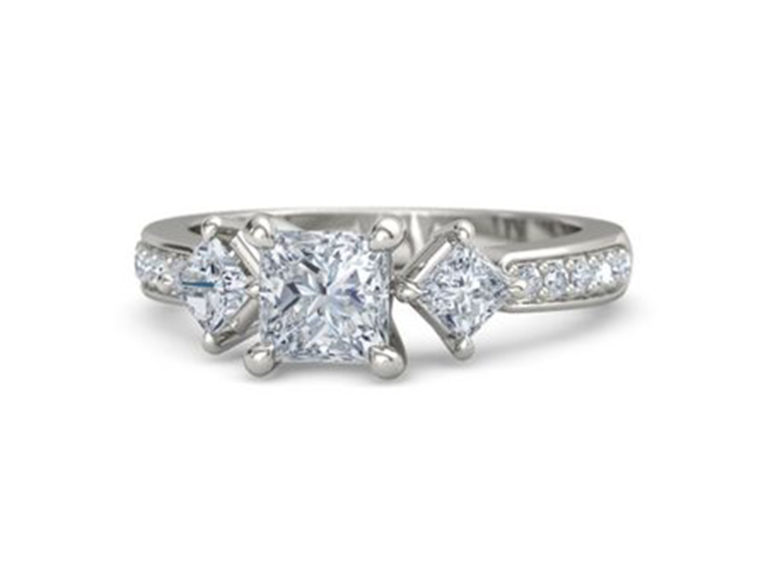 Three princess cut diamonds and pave diamonds on silver band