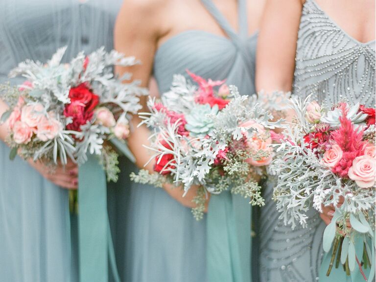 bridesmaids in blue gray holding wild bouquets