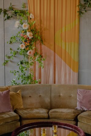 Velvet Couch Lounge Space and Retro 1970s-Inspired Backdrop, Hanging Florals