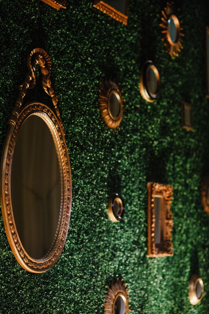 Antique gold mirrors hung from a lush green wall serving as a stunning backdrop for the live band.