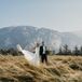 Adventurous Couple Posing for Wedding Photos in the Canadian Mountains