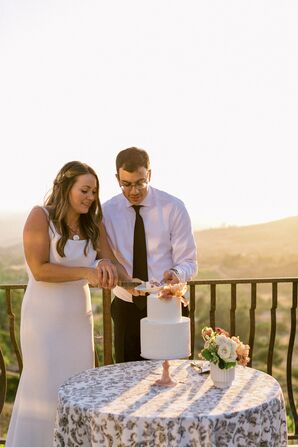 Couple Cutting Wedding Cake at Sunset