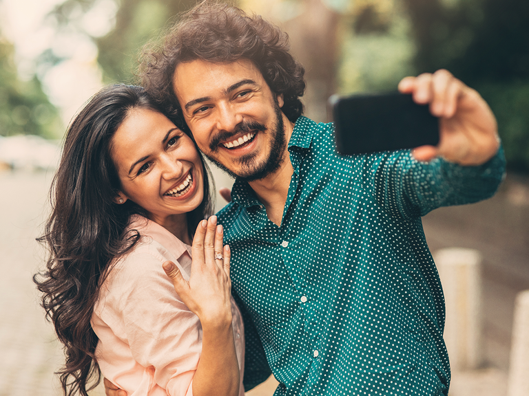 Engaged couple posing for selfie
