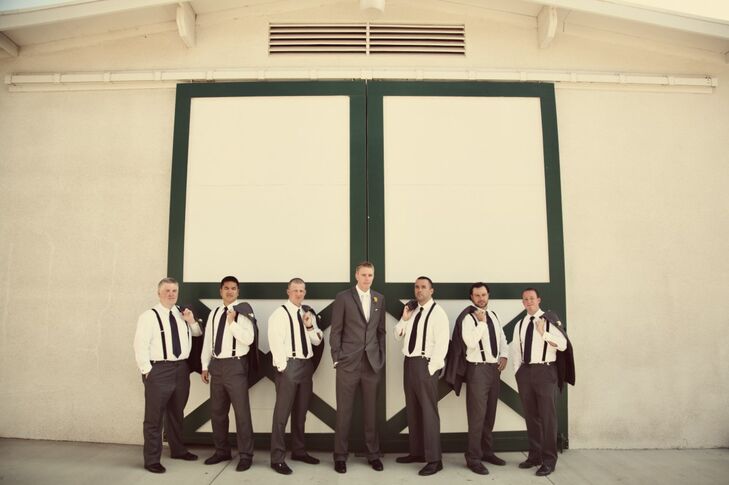 Groomsmen wore more casual outfits with suspenders (and flung their jackets over their shoulders) for this picture with the groom -- who stood out in his white on white charcoal suit ensemble.