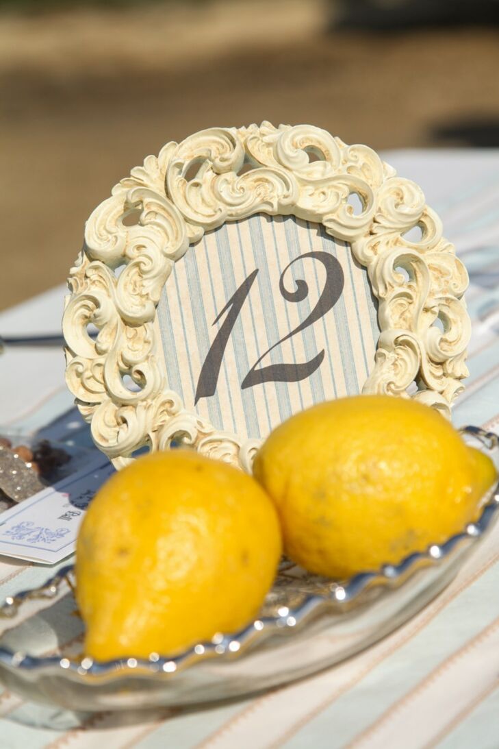 Table numbers at the reception were patterned and framed with antique photo frames and lined with interesting farm-fresh details -- like these lemons.